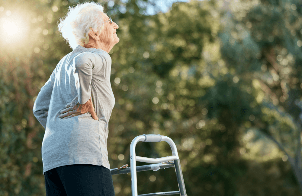 a happy old woman hiking with a stretcher in a park